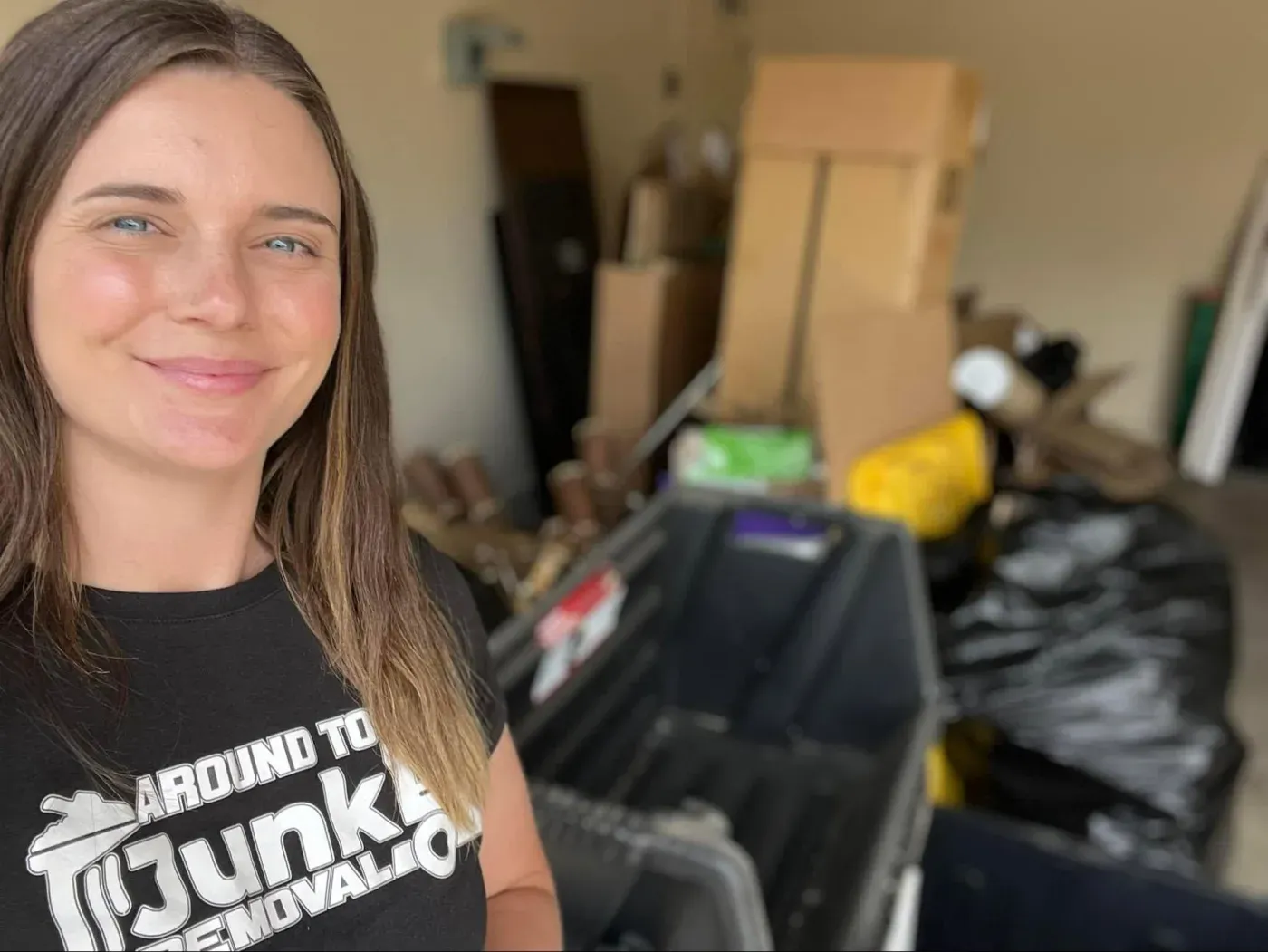 A crew member in front of a full garage cleanout in Sun City Grand