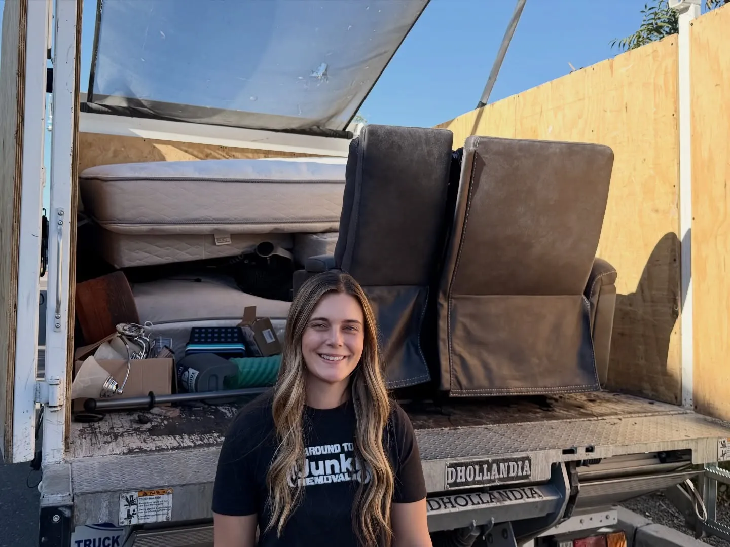 A crew member in front of a loaded Around Town truck