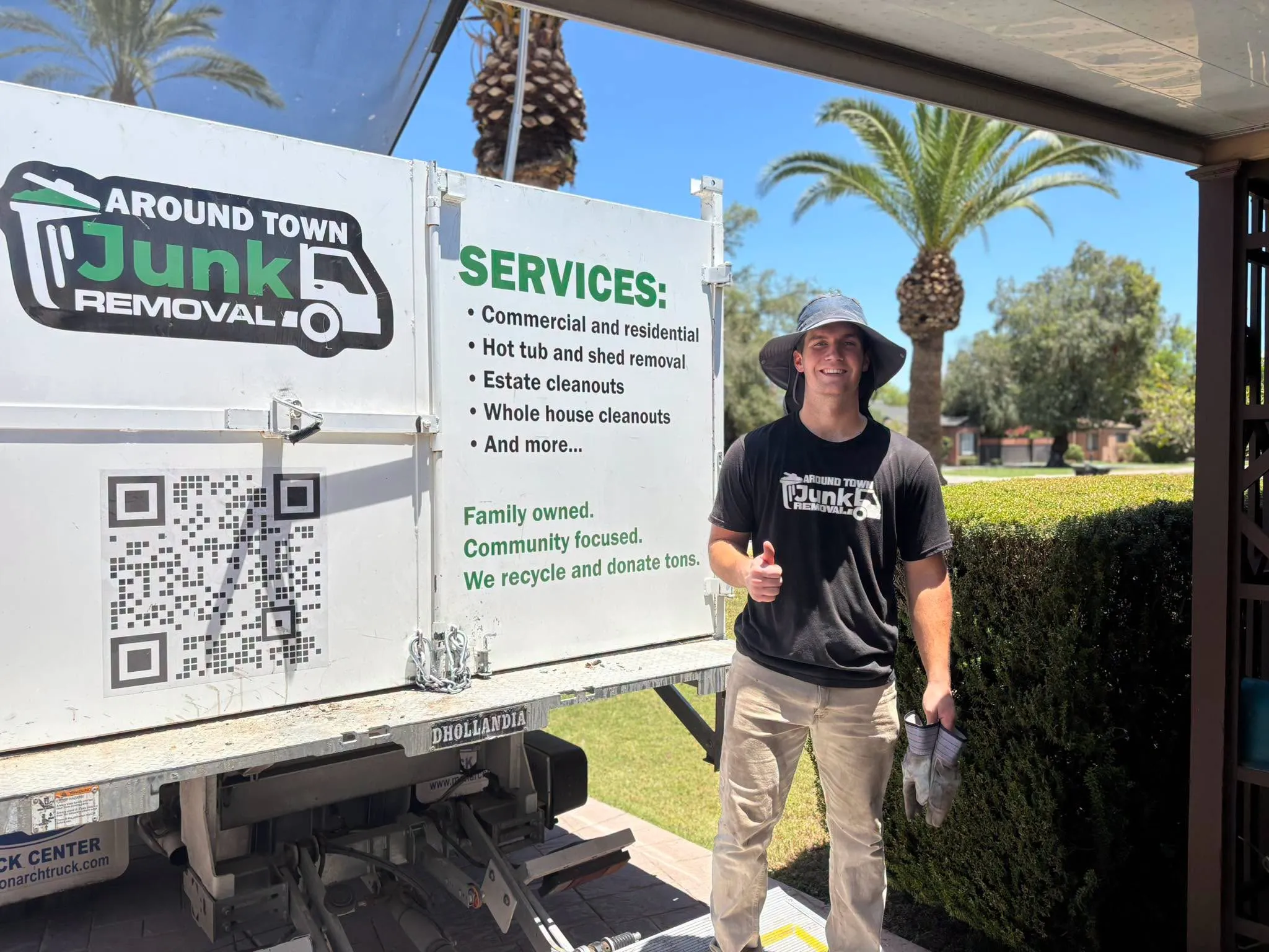 Crew member next to the truck panel listing Around Town services